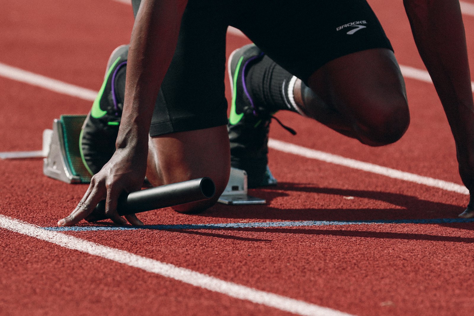 Sprinter set in the starting blocks on a running track